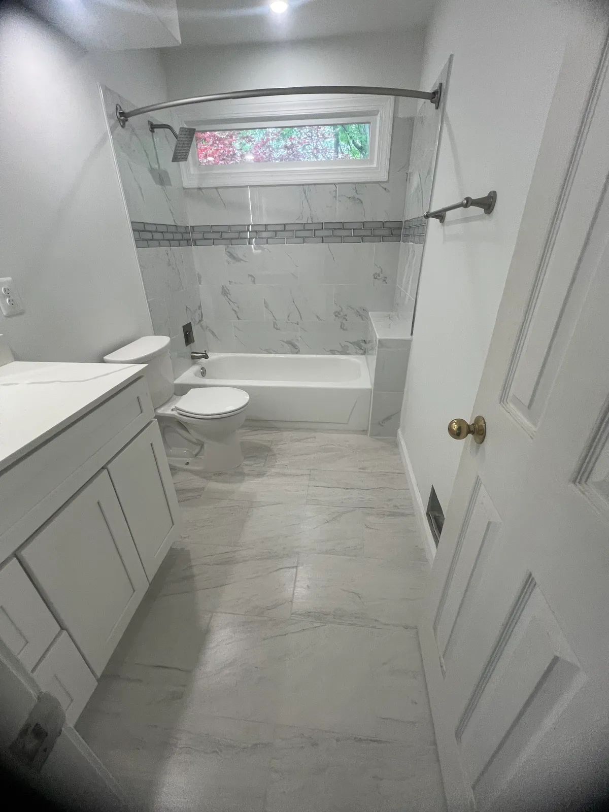 Custom tile shower surround with glass enclosure