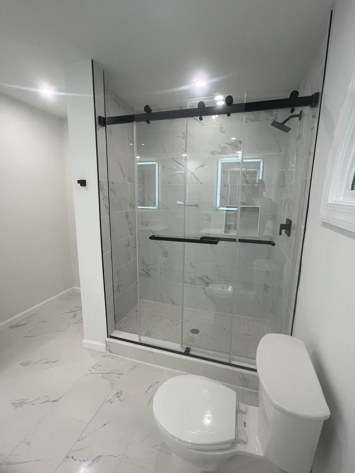 Updated bathroom with new lighting and mirror