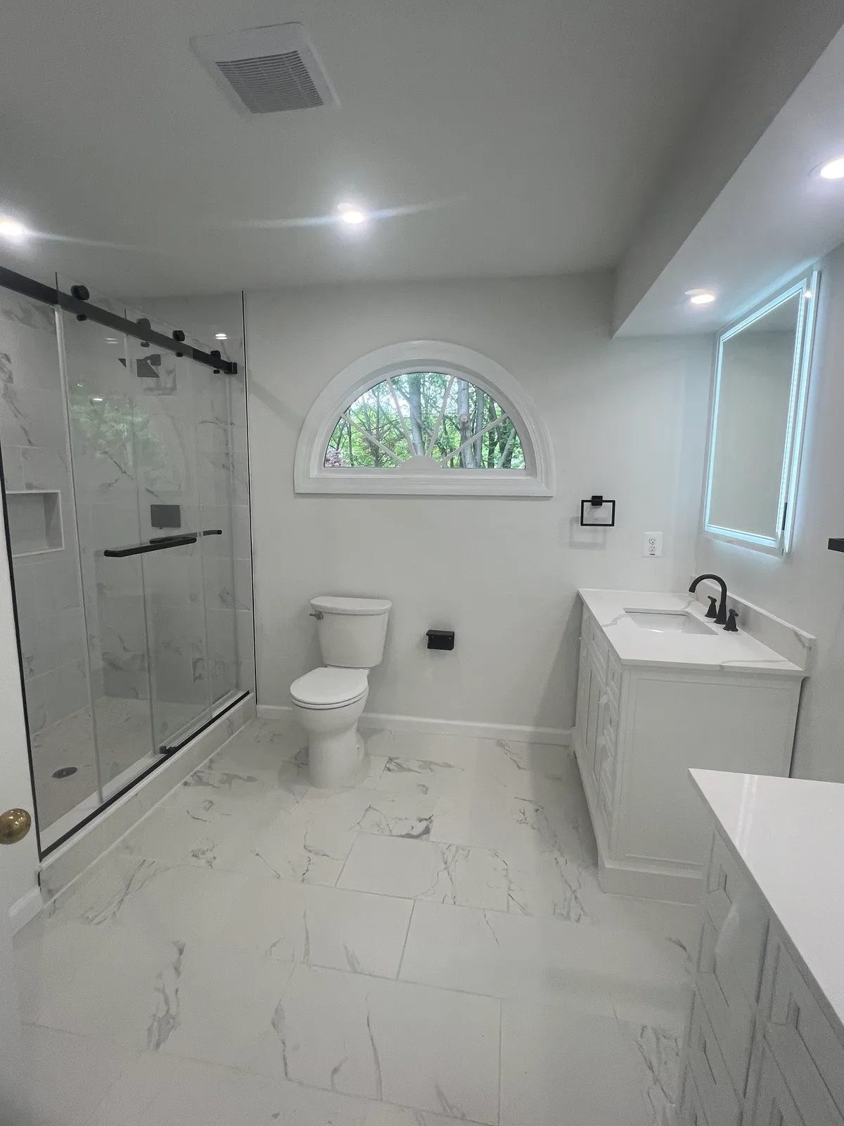 Bathroom renovation with tiled floor and trim work